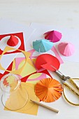 Hand-crafting paper umbrellas: cutting paper circles