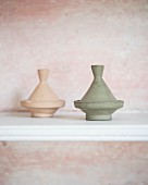 Two pastel tagine-shaped ornaments on white shelf