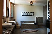 Ethnic-style bathroom with countertop sinks, masonry bathtub and open-plan shower area