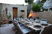 Set table in twilit courtyard of Mediterranean bungalow