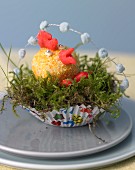 Coconut cockerel in Easter nest made of moss