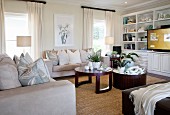 Pale sofa set with arranged scatter cushions and dark wooden coffee table in living room