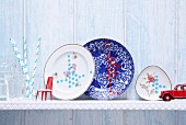 Hand-decorated porcelain plates on wall-mounted shelf
