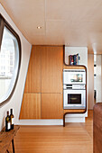 Custom, fitted cupboards with integrated appliances in houseboat kitchen