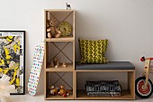 Simple, cubic, modular shelving with bench and nostalgic toys in child's bedroom