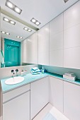 Bathroom with white fitted cabinets and turquoise accents