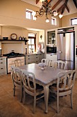 Postmodern dining set painted pale grey in rustic kitchen with modern accents