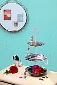 Hand-crafted cake stand made from pewter plates and used to display keys and flowers