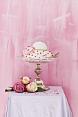 Romantic, festive cake on elegant cake stand decorated with roses