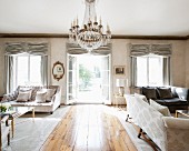 Antique furniture, chandelier and French windows in luxurious interior