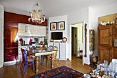 Eclectic kitchen with dining area and artistic chandelier