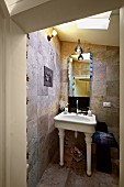 Bathroom with white, vintage, pedestal sink and stone tiles