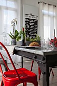 Industrial-style dining table and glossy red chairs