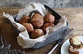 Home-baked, gluten-free buns with flax seed in bread basket