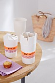 Closable metal containers for small cakes made from paper cups and masking tape