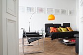Black furniture and yellow arc lamp in white living room