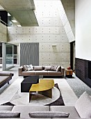 Modern living room with gallery and concrete walls