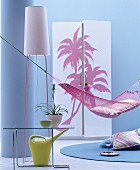 Hammock, standard lamp and wardrobe with palm-tree motifs on front