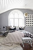 Attic bedroom with Gothic window and mixture of patterns