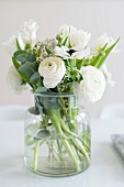 Glass vase of white spring flowers