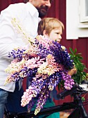 Child carrying flowers for midsummer festival