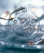 Hand-blown, transparent glass bauble with reindeer figurine inside