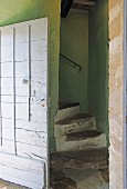 Stone steps in green stairwell
