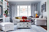 Vintage table on pale blue patterned rug in living room decorated with Advent