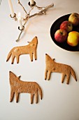 Gingerbread wolves, lit candles in candelabra and fruit bowl