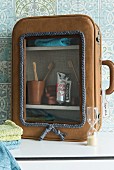 A bathroom cabinet made from an old suitcase