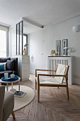 Scandinavian armchair on plain herringbone parquet floor in foyer