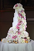 Multi-tiered wedding cake romantically decorated with roses