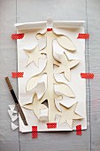 A paper garland being cut out