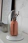 Copper-coloured drinks can used as vase under glass cover