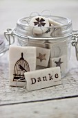Hand-made polymer clay gift tags in storage jar
