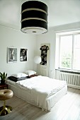 Large retro lampshade in bright bedroom