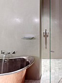 Retro, industrial-style designer bathtub and walk-in shower with polished, glazed walls
