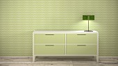 Green table lamp on sideboard against green and white polka-dot wallpaper