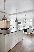 Country-house kitchen with wooden ceiling and dining table