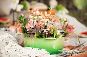 Flower arrangement in green saucepan outdoors