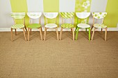 Simple wooden chairs revamped with patterns of fresh green paint