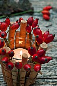 Tealight in bamboo basket with rose hips