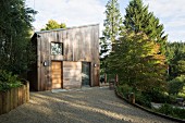 Gravel courtyard in front of contemporary wooden house
