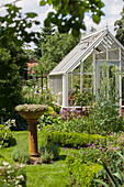 Victorian greenhouse in idyllic garden