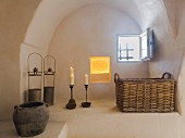 Rustically decorated arched niche with small window in restored Apulian trullo