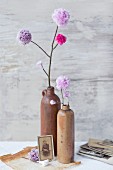 Hand-made, artificial, lilac pompom flowers in stoneware vases