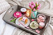 Romantically arranged breakfast and gifts on tray