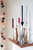 Candles of various colours in Scandinavian candlesticks