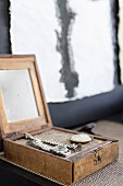 Watches displayed in open, vintage, wooden box with mirror inside lid