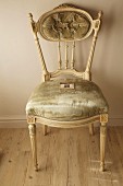 Elegant, antique Rococo chair with pastel green velvet cover and carved elements